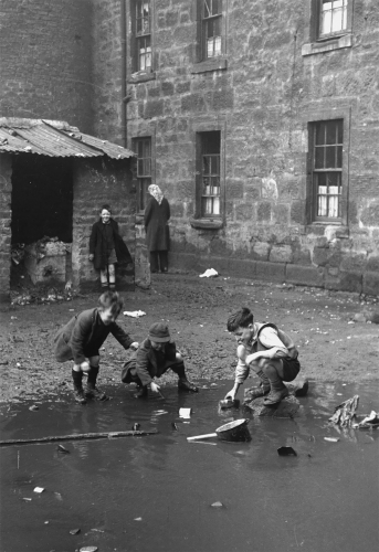 Bert Hardy Boys play in a puddle in the slums of Gorbals, Glasgow on January 31, 1948. .jpg